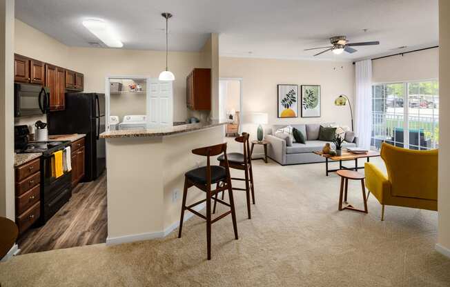 a spacious living room with a kitchen and dining area