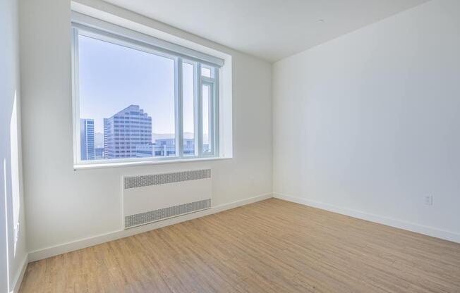 A room with a window overlooking a cityscape.