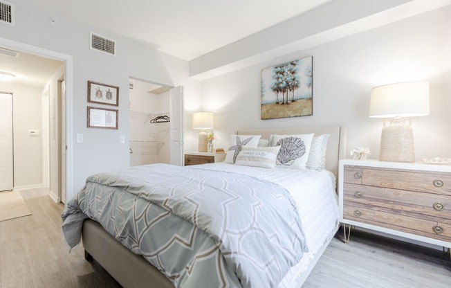 a bedroom with a bed and a dresser with a mirror at Heritage Bay, Jensen Beach Florida