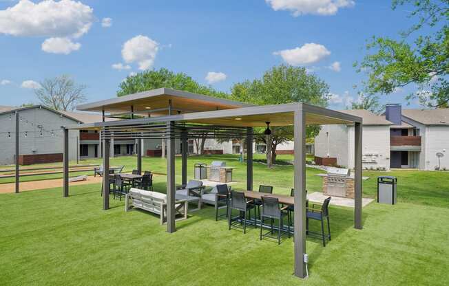 a patio with a table and chairs under a canopy