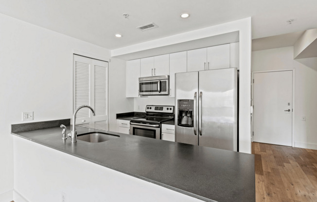 Experience culinary delight in this sleek, modern kitchen.