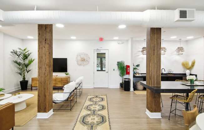 a living room and dining room with a table and chairs