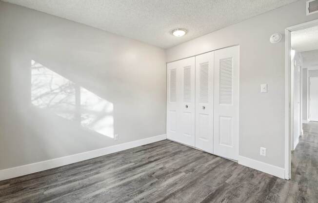 A room with a white door and a window.