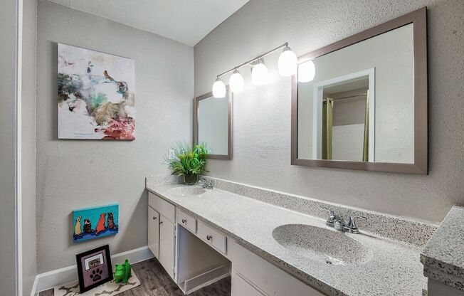 A bathroom with a sink, mirror, and lights.