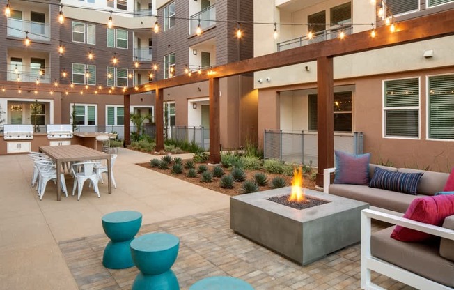 A patio with a fire pit and seating area.