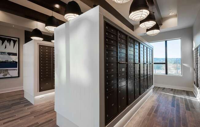 A modern room with a white column and a row of black lockers.