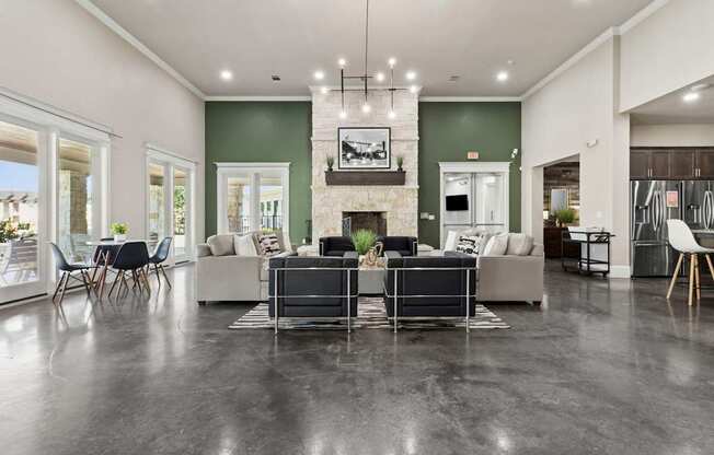 A modern living room with a fireplace and a grey sofa.