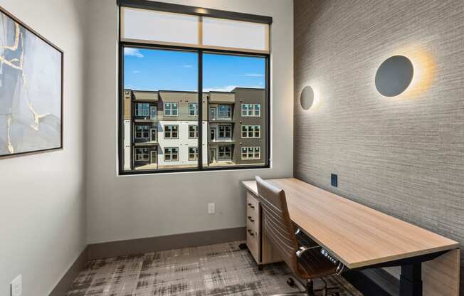 a conference room with a window and a desk and chairs