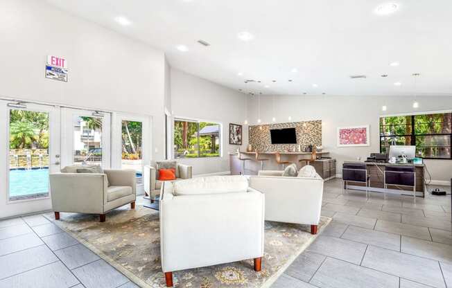 a living room with couches and chairs and a pool at Waterford Park Apartment Homes, LLC, Lauderhill