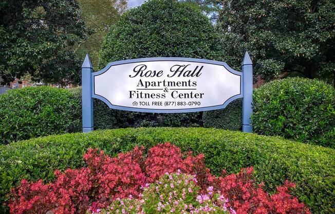 a sign above a flower garden