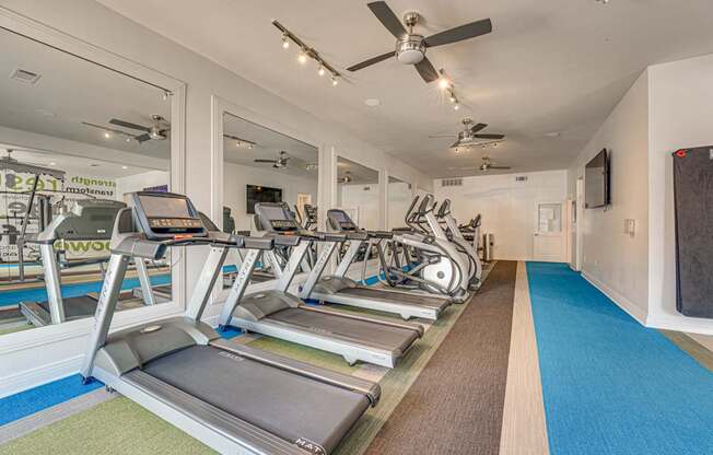 Fitness center with cardio equipment at Vue Live Oak Apartments, Dallas, TX