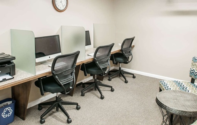 Resident business center with iMac workstations at The Pepper Building apartment complex in Philadelphia, located at 1830 Lombard Street near Rittenhouse Square.