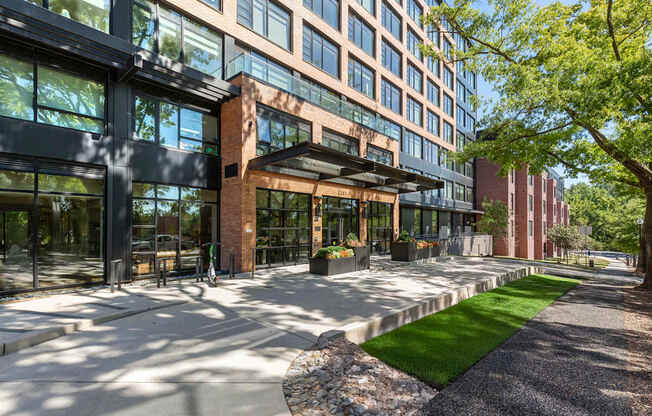 A modern building with a brick entrance and glass windows.