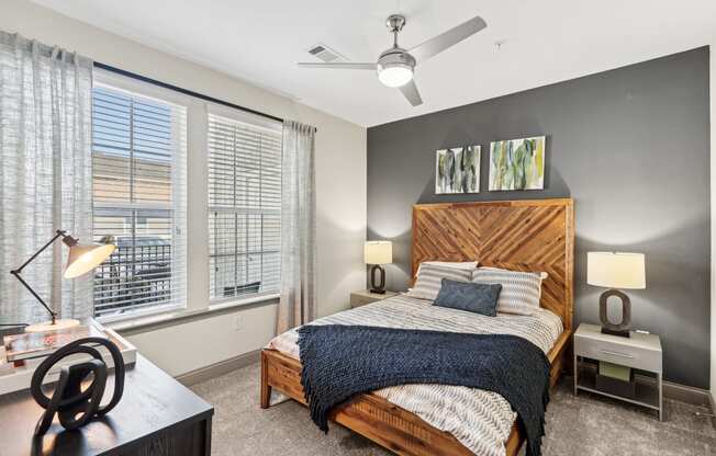 a bedroom with a bed and a ceiling fan