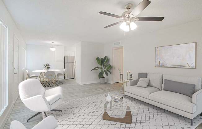 A living room with a white chair and a white couch.