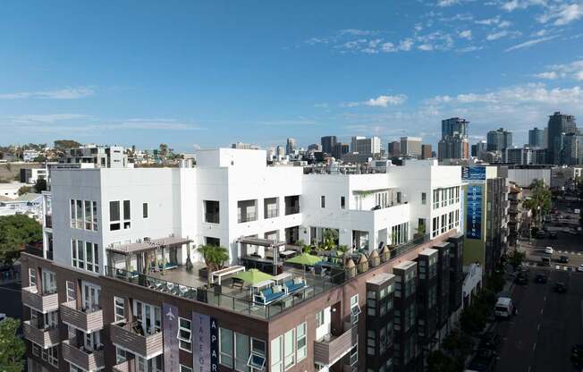 A modern apartment complex with a clear blue sky above.