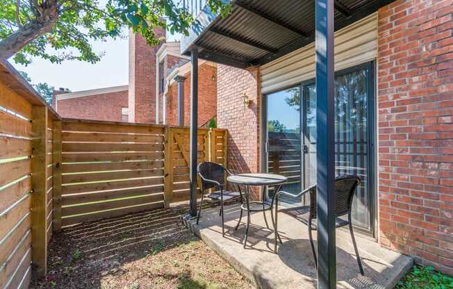 A patio with a table and chairs is shown.