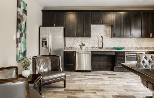 a kitchen with dark wood cabinets and a stainless steel refrigerator