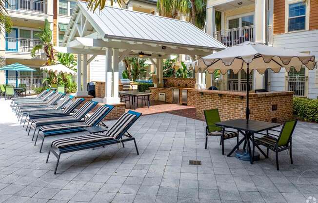 a row of chairs and umbrellas on a patio