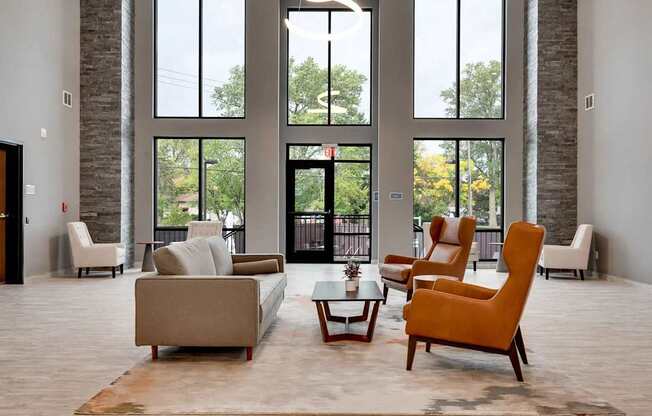 a living room with couches chairs and a table. Circle Pines, MN Lexington Lofts