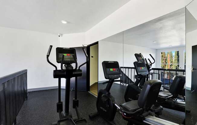 A gym with treadmills and elliptical machines.