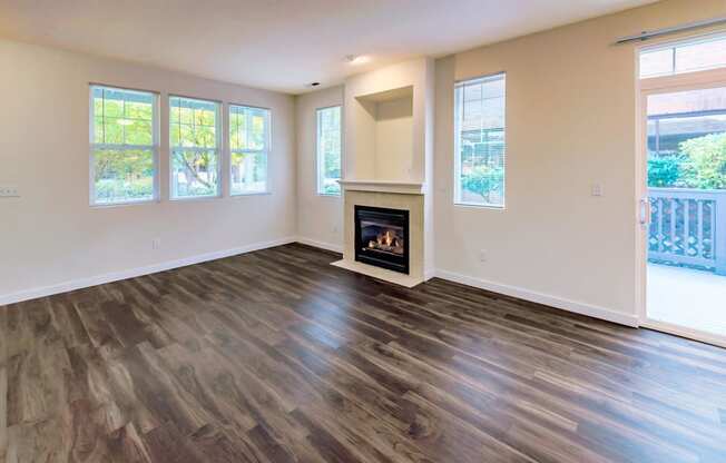 a living room with a fireplace and wooden floors