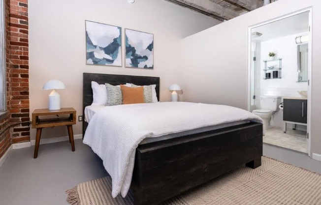 a bedroom with a bed and a bathroom