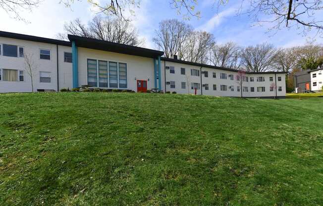 Lush green lawn and mature trees outside of The Flats at Jackson Square