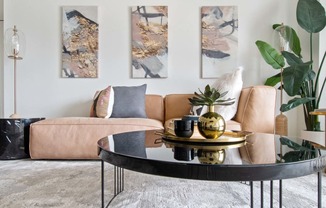 a living room with a brown couch and a black coffee table