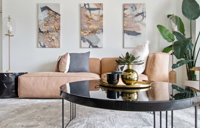 a living room with a brown couch and a black coffee table