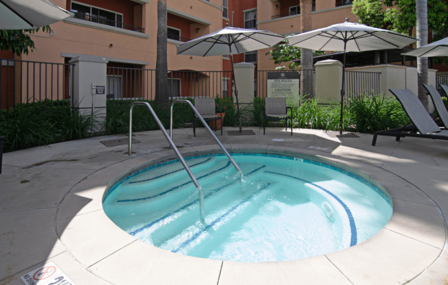 A small pool with a fountain in the middle.