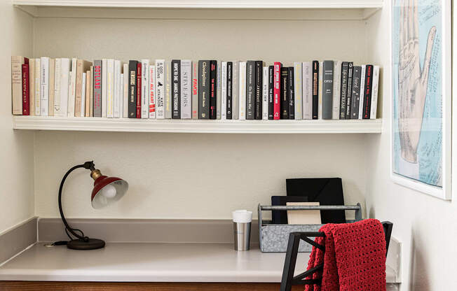 a home office with a desk and bookshelves