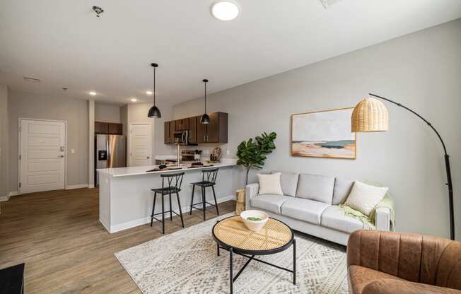 a living room with a couch and a kitchen with a bar at EagleRidge Plaza Residences, Fargo, ND, 58104