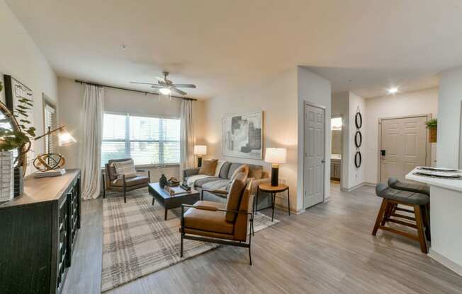 Gorgeous Modern Living Room with Two Tone Paint Colors and Wood Plank Vinyl Flooring (in Select Units) at Ashby at Ross Bridge, Hoover