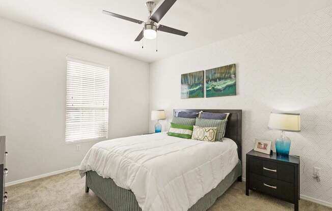 a bedroom with a bed and a ceiling fan