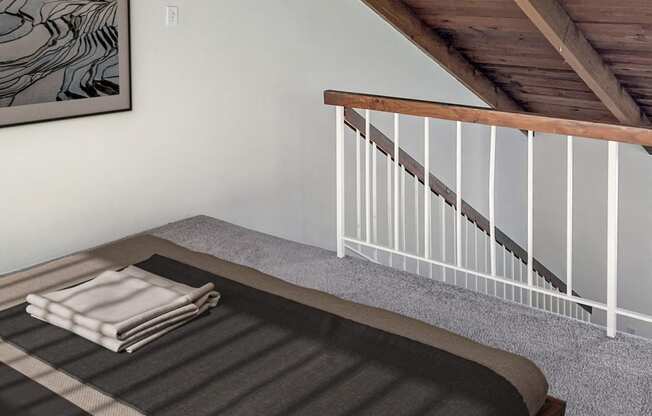 a bedroom with a bed and a staircase in a loft