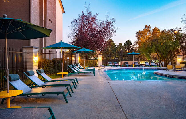 Clover Creek Apartments Pool Area and Lounge Chairs at Dusk