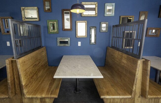 A room with blue walls and a table surrounded by chairs.