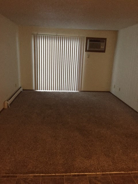 an empty room with a window in the background