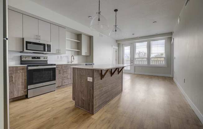 an empty kitchen with a large island in the middle