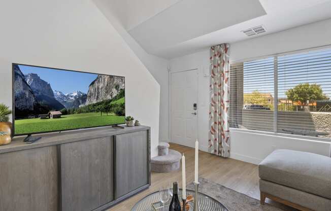 a living room with a tv and a view of a mountain