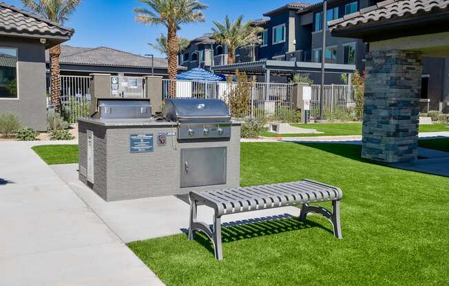 Bench and Gas BBQ grills near pool, game area and ramada.