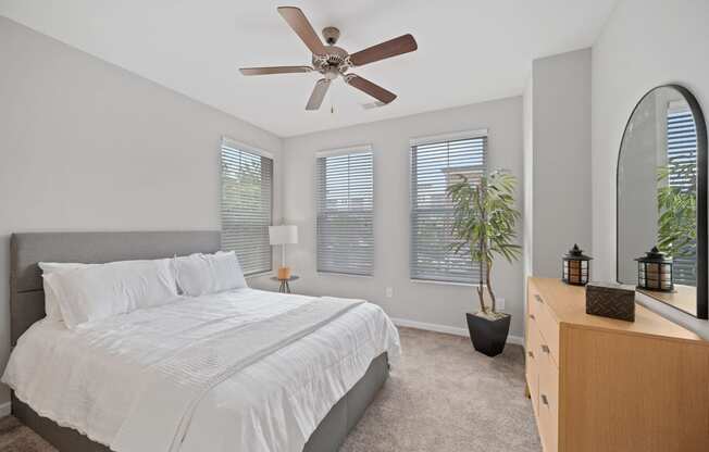 a bedroom with a large bed and a ceiling fan