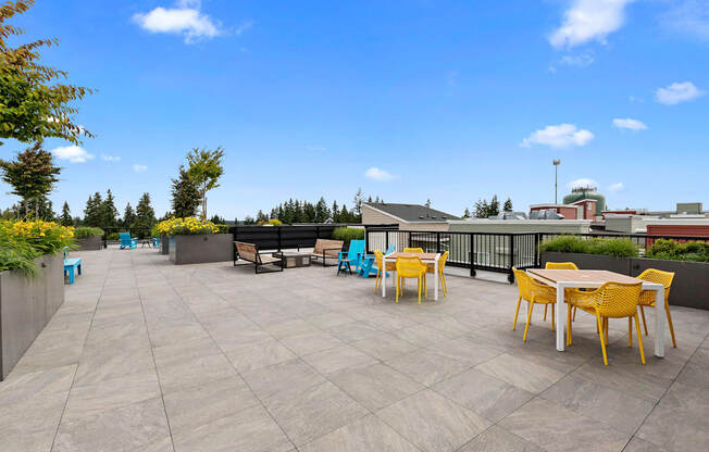 a resident rooftop terrace with tables and chairs at Arabella Apartment Homes, Shoreline, Washington 98155