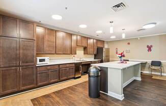 A kitchen with wooden cabinets and a white counter.