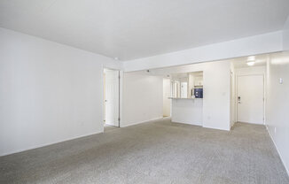 living room and kitchen with carpeting at North Pointe Apartments in Elkhart, IN