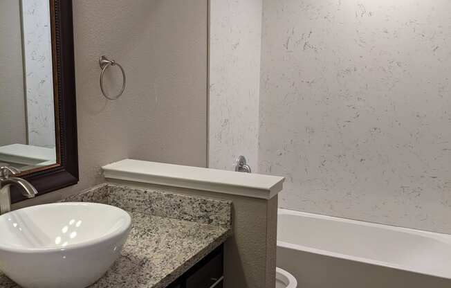 View of bathroom vanity with surface mounted bowl sink