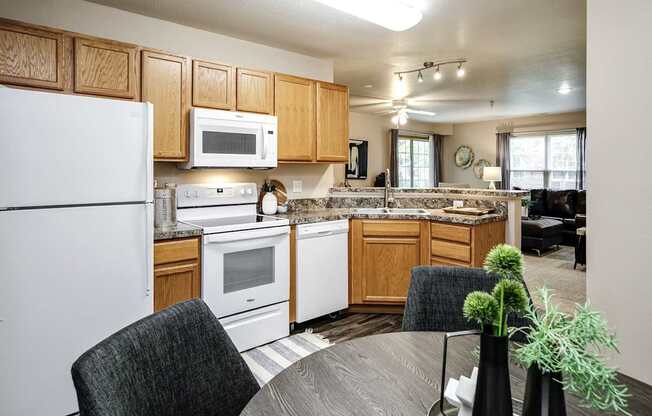 A kitchen with a white refrigerator, microwave, and oven. at Tranquility Pointe, Omaha, NE