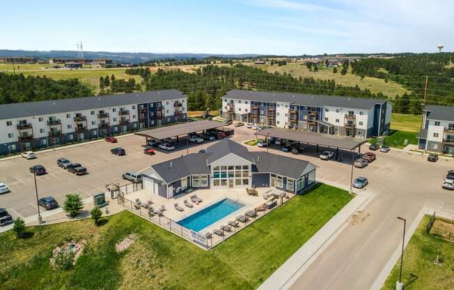 an aerial view of an apartment building with a swimming pool