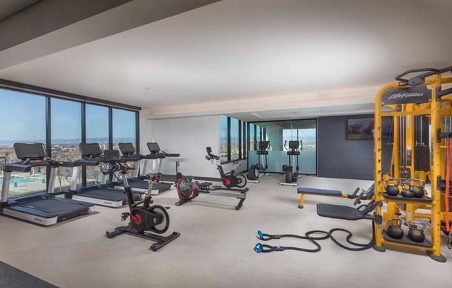 Club-quality fitness center overlooking pool deck with mountain views